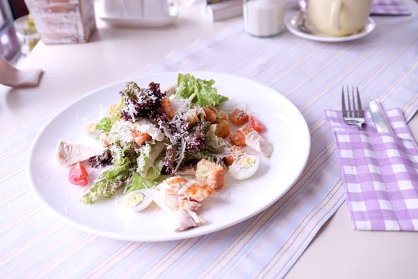 Caesar salad on table in cafe — Stock Photo, Image