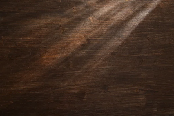 Haz de luz sobre fondo de madera — Foto de Stock