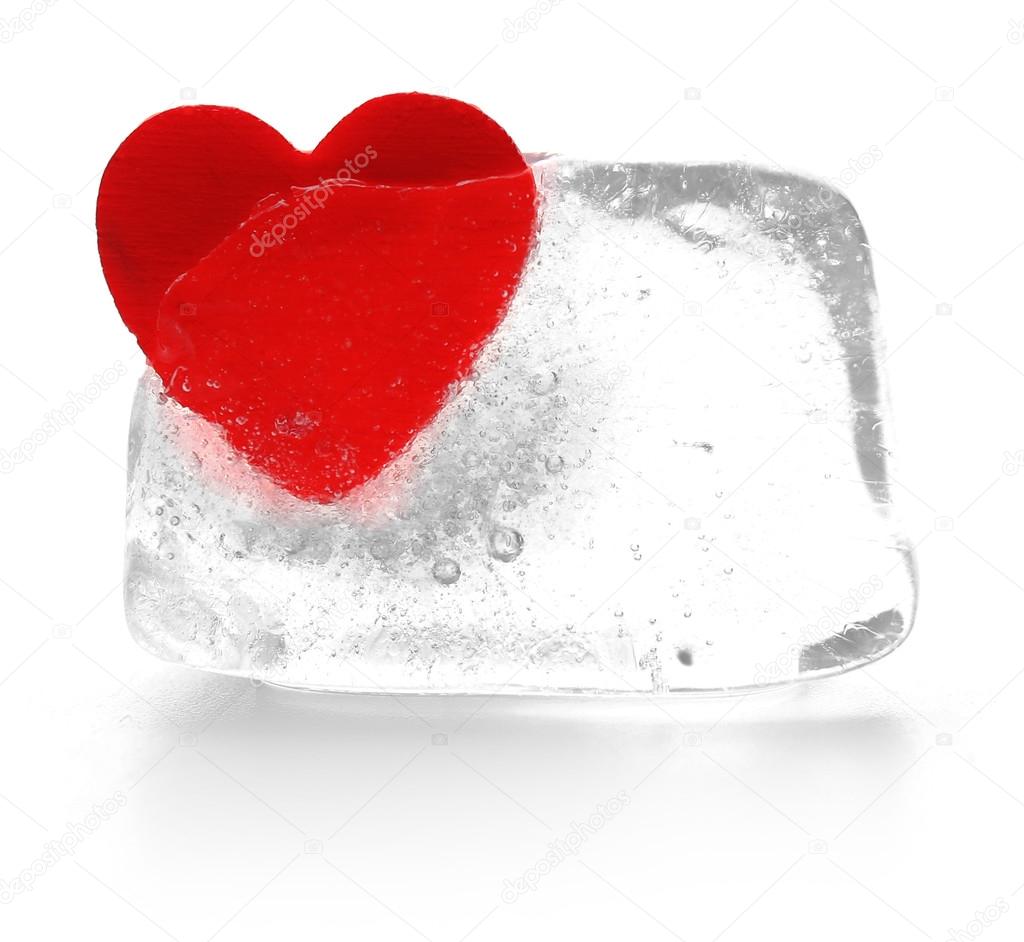 Red heart in ice cube isolated on white