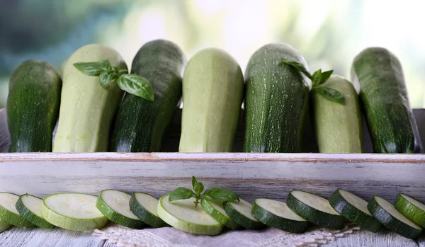 Fresh zucchini with squash and basil on bright background — Stock Photo, Image