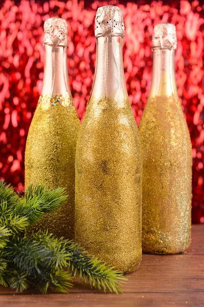 Flaskor champagne med Juldekoration på ljus bakgrund — Stockfoto