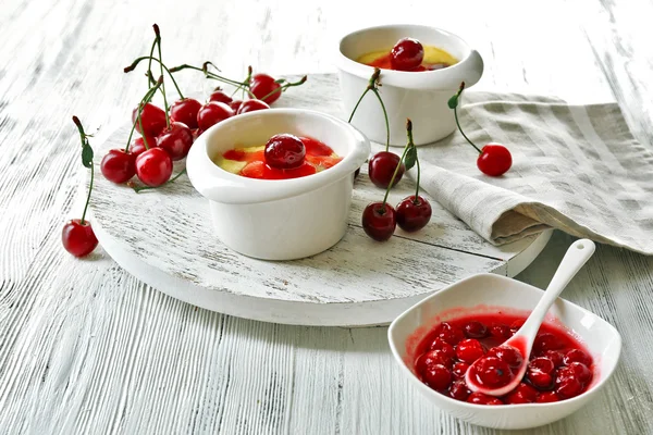 Tasty pudding with cherries on table close up — Stock Photo, Image