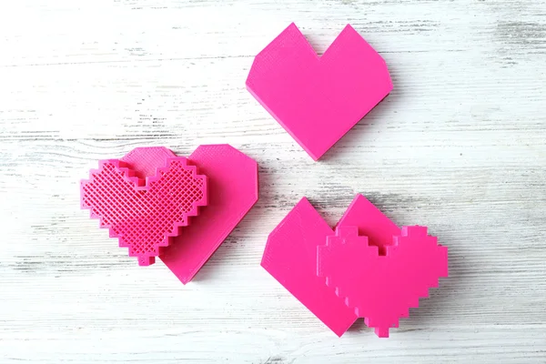 Plastic hearts on wooden background — Stock Photo, Image