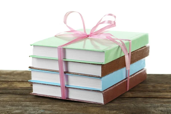 Stack of books with ribbon on light background — Stock Photo, Image