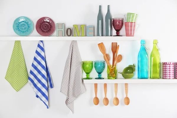 Kitchen utensils on wooden shelves — Stock Photo, Image