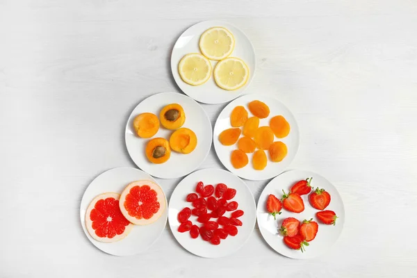 Set of orange products on wooden background — Stock Photo, Image