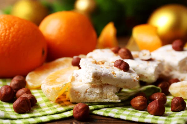 Nougat with oranges and Christmas decoration — Stock fotografie