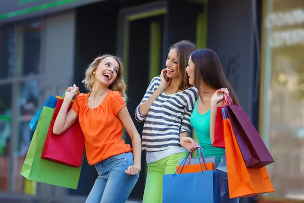 Beautiful young women with shopping bags on city street Stock Picture