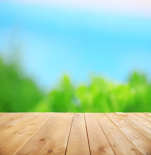 Wooden table with abstract blur — Stock Photo, Image