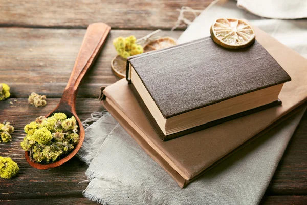 Old books with dry flowers and lemon on table close up — Stock Photo, Image