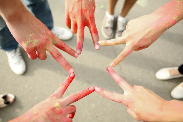 Hands of young people with Indian dyes on Holi color festival — Stock Photo, Image