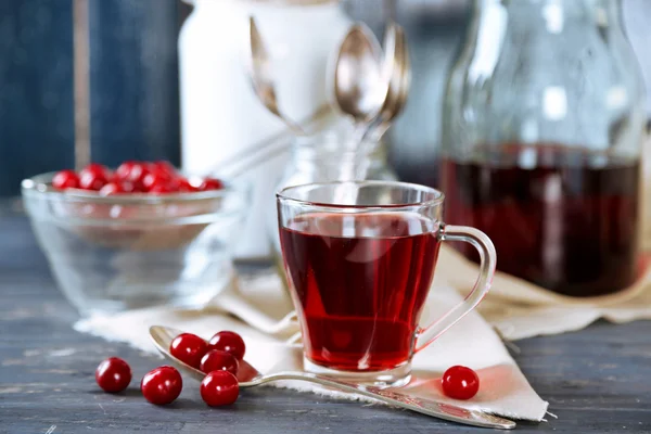 Sweet homemade cherry juice on table, on color wooden background — Stock Photo, Image