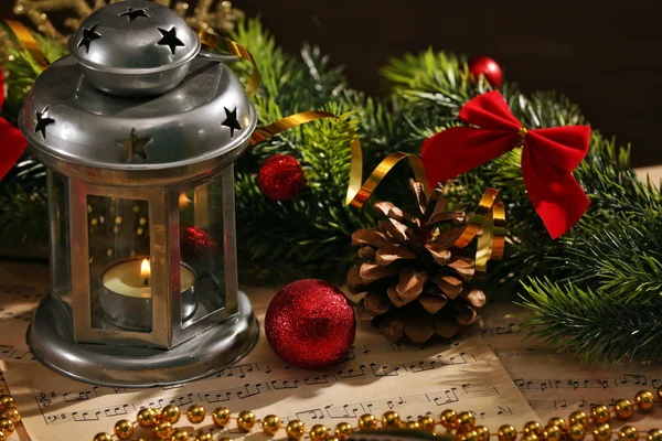 Christmas decorations on music sheets, closeup — Stock Photo, Image