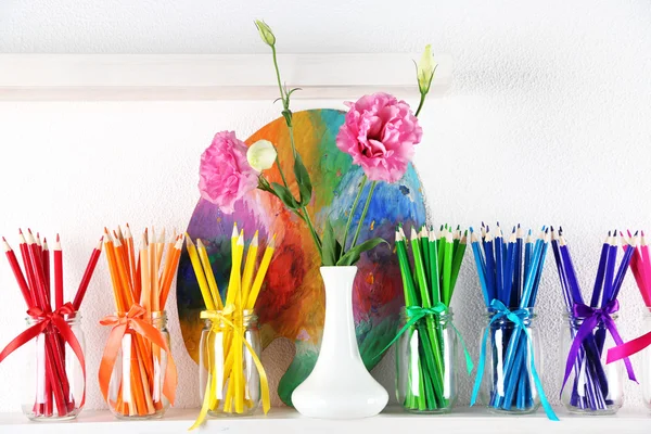 Bright pencils in glass jars on shelf — Stock Photo, Image