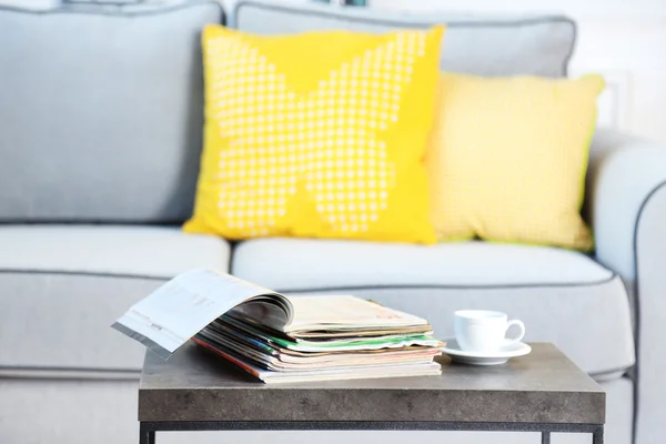 Magazines on table in living room, close up