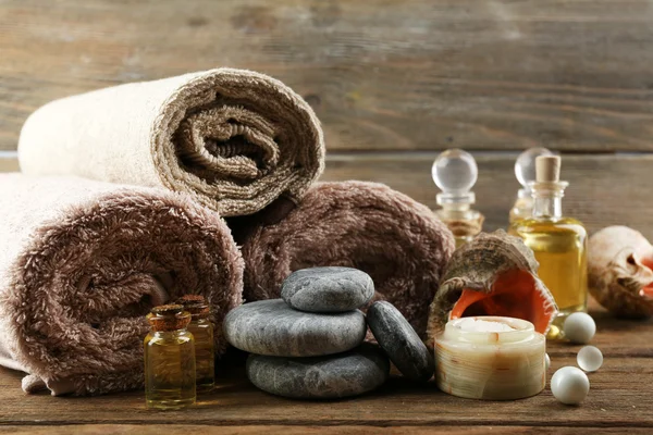 Stack of spa stones and spa treatments on wooden background — Stock Photo, Image