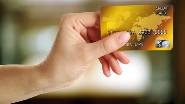 Hand holding credit card on abstract background — Stock Photo, Image