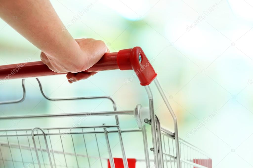 Young woman with shopping cart in store