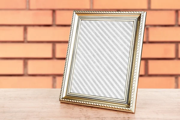 Old frame standing on table — Stock Photo, Image
