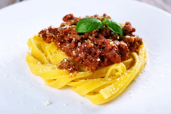 Pasta Bolognese with parmesan and basil on plate close up — Stock Photo, Image