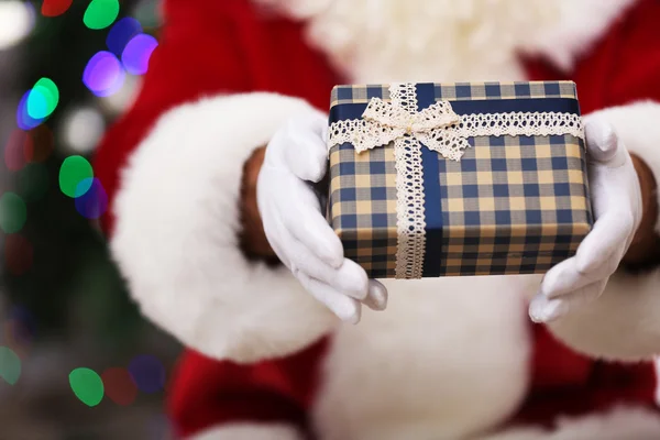 Santa holding gift — Stock Photo, Image