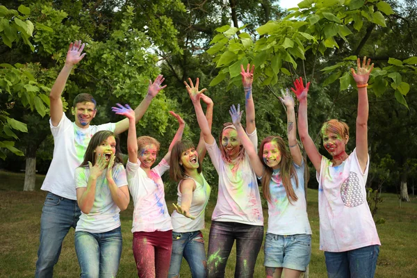 Young people celebrate Holi color festival in park