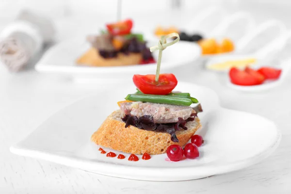 Tasty canapes on wooden table — Stock Photo, Image