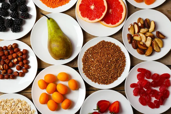 Different products on saucers — Stock Photo, Image