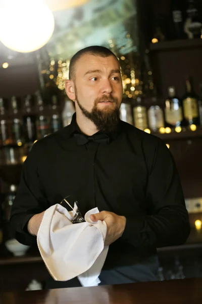 Bartender wipes glasses at work — Stock Photo, Image