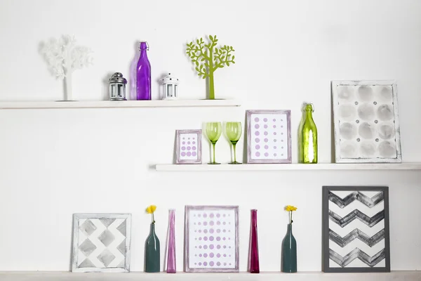 Different home objects and decoration on shelves on white wall background — Stock Photo, Image