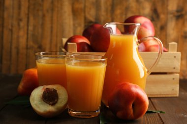 Şeftali suyu ve ahşap arka plan üzerinde olgun şeftali