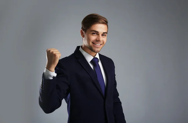Elegant man in suit on gray background — Stock Photo, Image