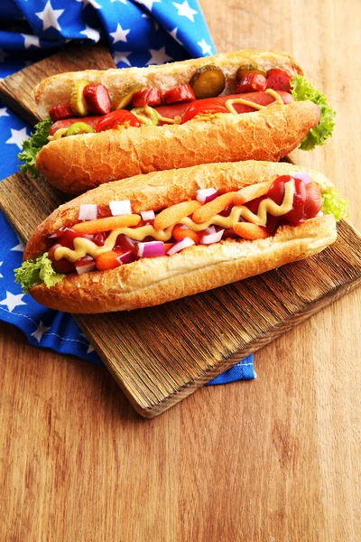 Fresh hot dogs on wooden background — Stock Photo, Image