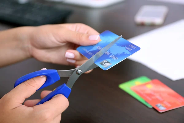 Hands cutting bank card with scissors — Stock Photo, Image