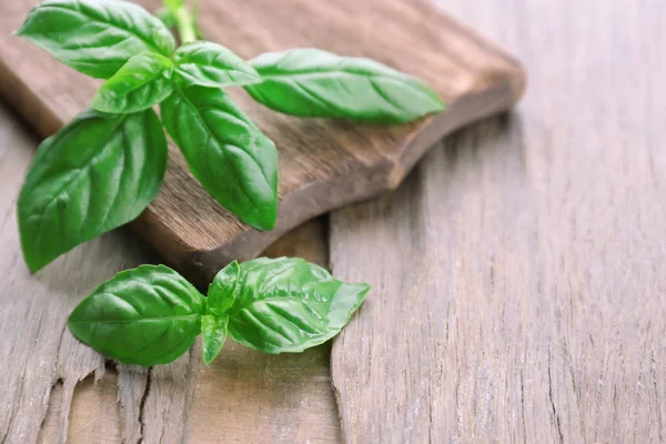 Green fresh basil on wooden background — Stock Photo, Image