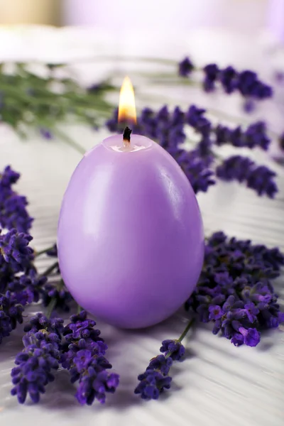 Candle with lavender flowers on table close up — Stock Photo, Image