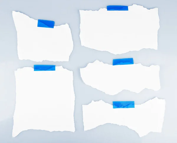 White pieces of paper attached on white background — Stock Photo, Image