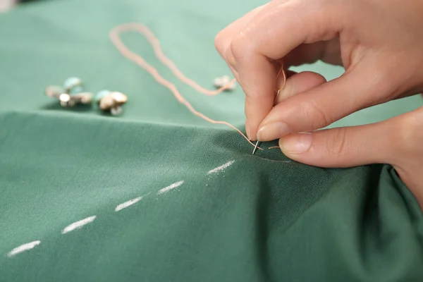 Closeup hands of seamstress at work with cloth fabric — Stock Photo, Image