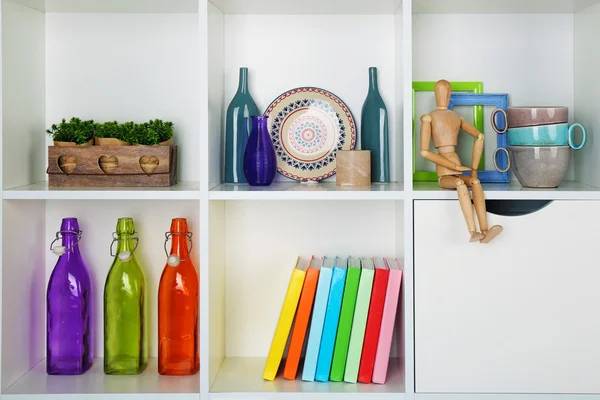 Beautiful white shelves with different home objects — Stock Photo, Image