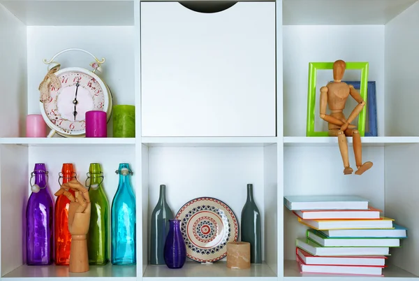 Beautiful white shelves with different home objects — Stock Photo, Image