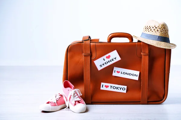 Suitcase with stickers on floor in room — Stock Photo, Image