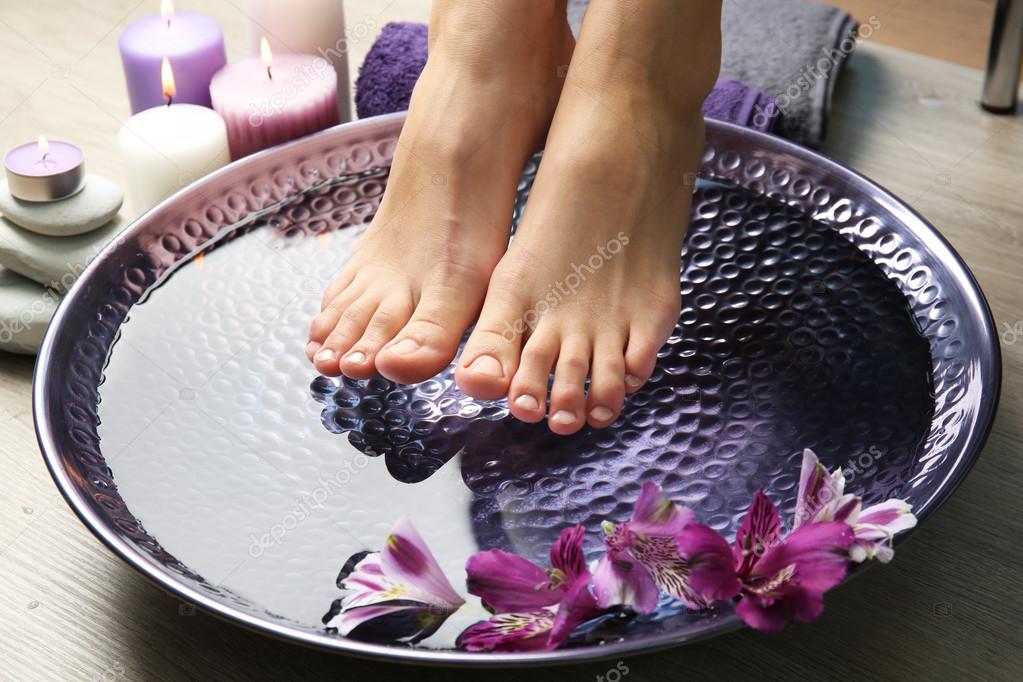 Female feet at spa pedicure procedure — Stock Photo © belchonock 83914002