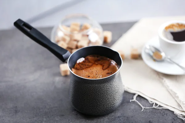 Turk of flavored coffee on table with napkin, closeup — Stock Photo, Image