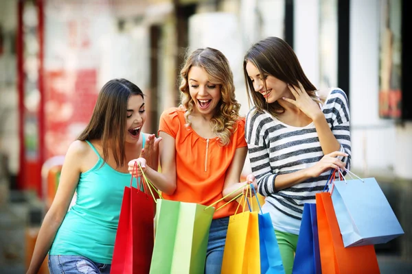 Beautiful young women with shopping bags on city street — Stock Photo, Image
