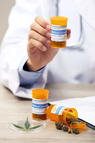 Doctor hand holding bottle with medical cannabis close up — Stock Photo, Image