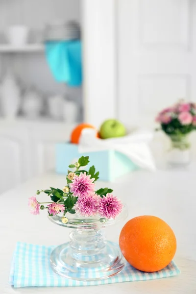 Beautiful flowers in vase on table, on light background — Stock Photo, Image
