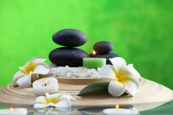 Still life with spa stones on green background — Stock Photo, Image