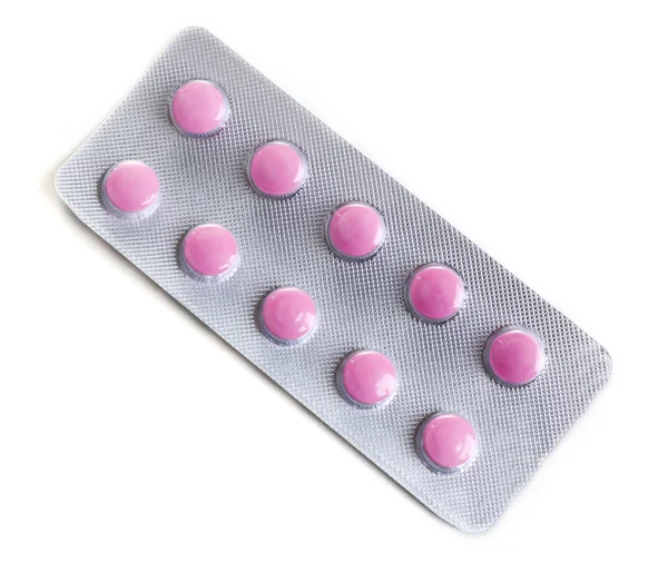 Tabletták csomagolva fólia elszigetelt fehér — Stock Fotó