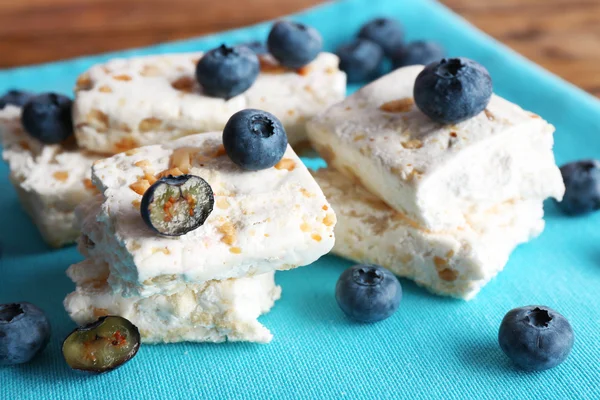 Sweet nougat with nuts and blueberries on napkin close up — Stock Photo, Image