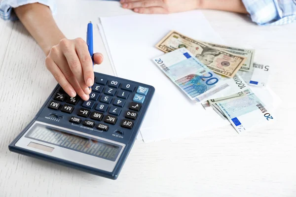 Accounting concept.Analyzing finance report with calculator — Stock Photo, Image